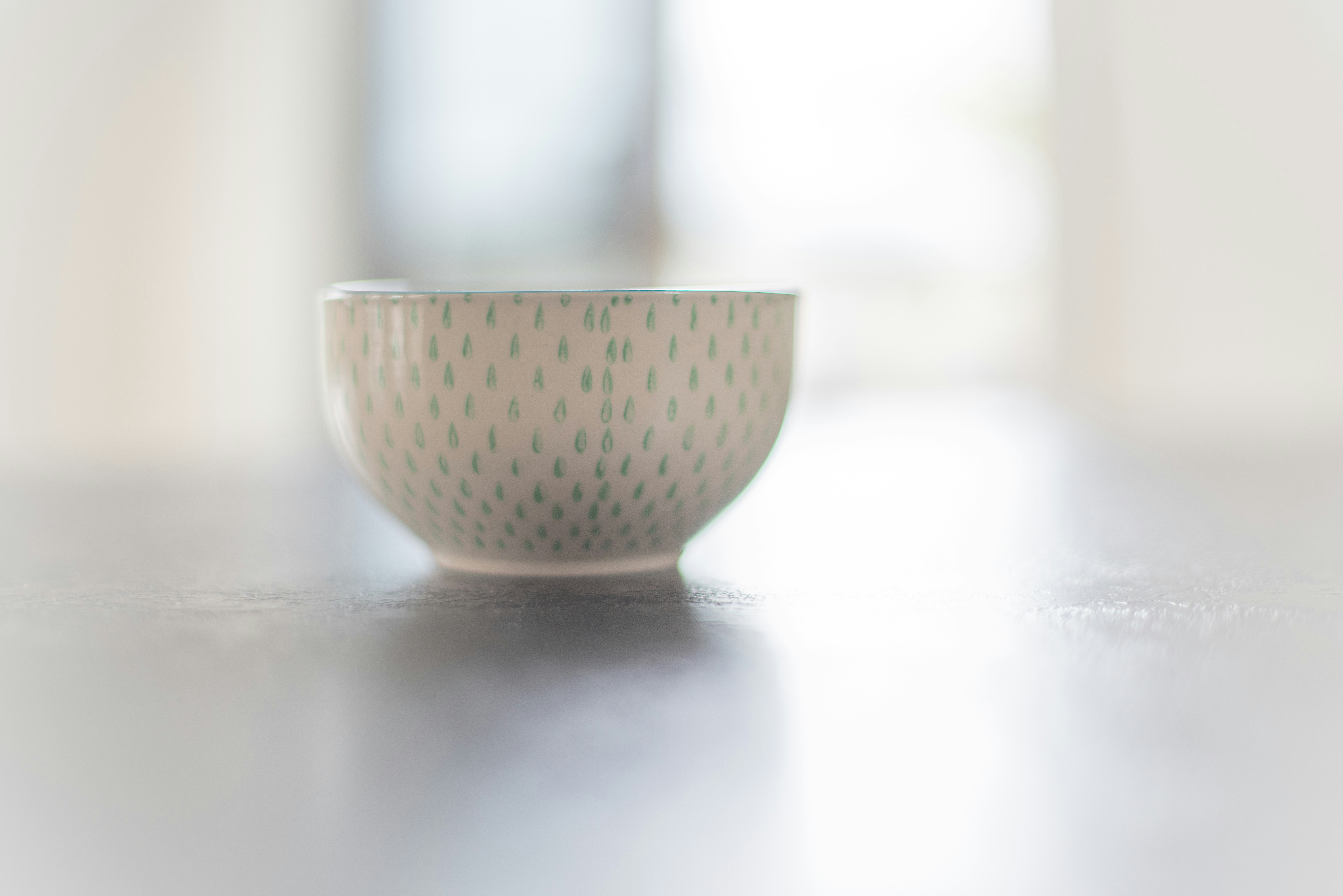 white ceramic bowl on white table